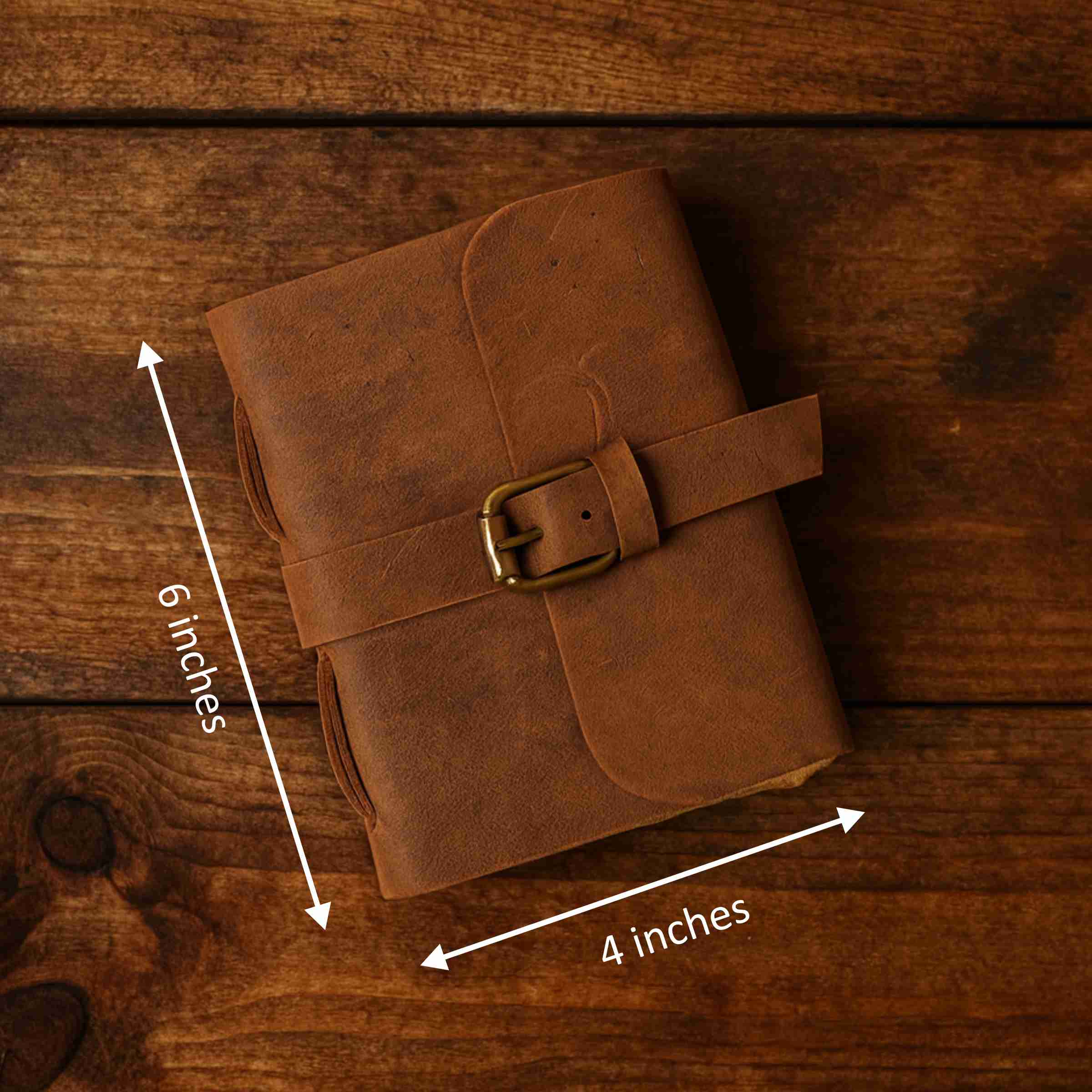 Brown leather notebook with dimensions on a wooden surface