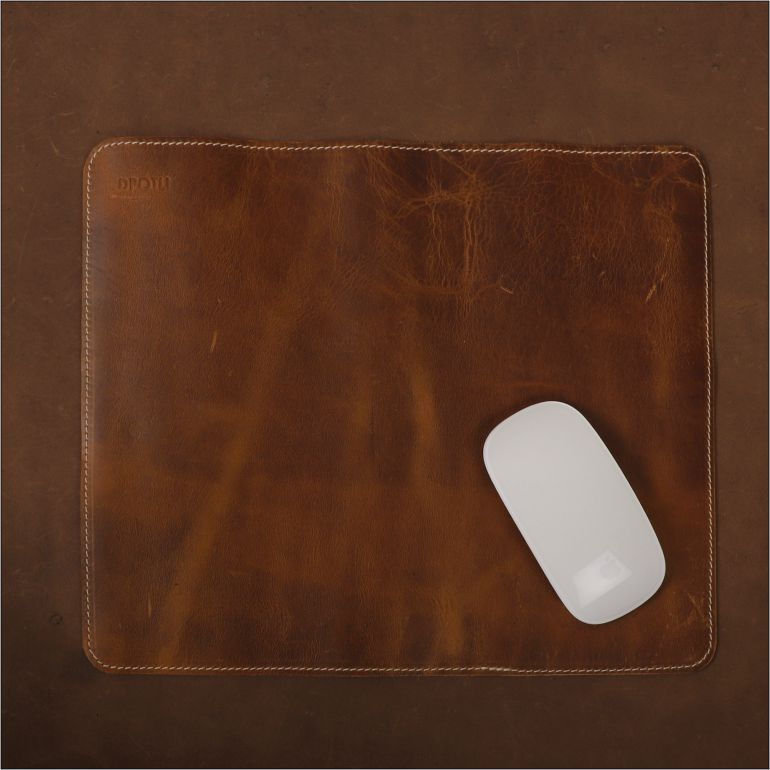 Brown leather mouse pad with a white mouse on a brown background