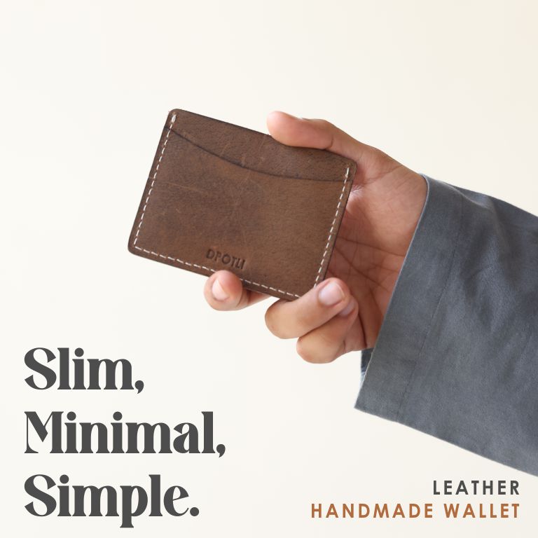 Hand holding a brown leather handmade wallet with text 'Slim, Minimal, Simple' on a light background