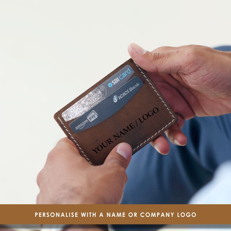 Brown cardholder with multiple cards held by a person against a light background