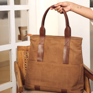 Brown tote bag with leather handles, showcasing its spacious and stylish design