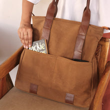 Load image into Gallery viewer, Brown tote bag with leather handles, showing its front pockets and minimalist design